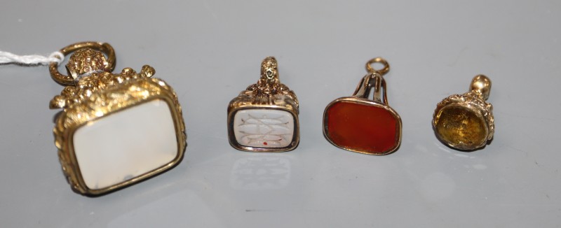 Four assorted 19th century gold plated and gem or hardstone set fob seals, largest 39mm.